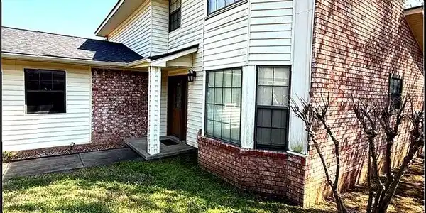 Image 3: View of front of home featuring brick siding and a