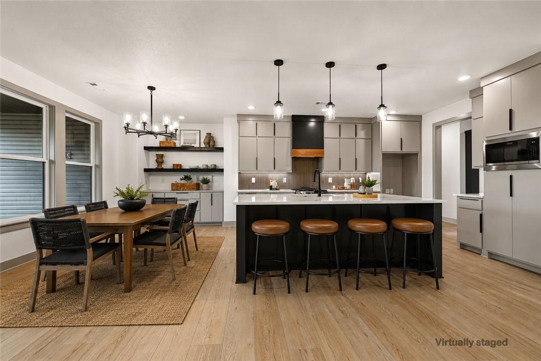 Image 3: Open-concept kitchen featuring an oversized island