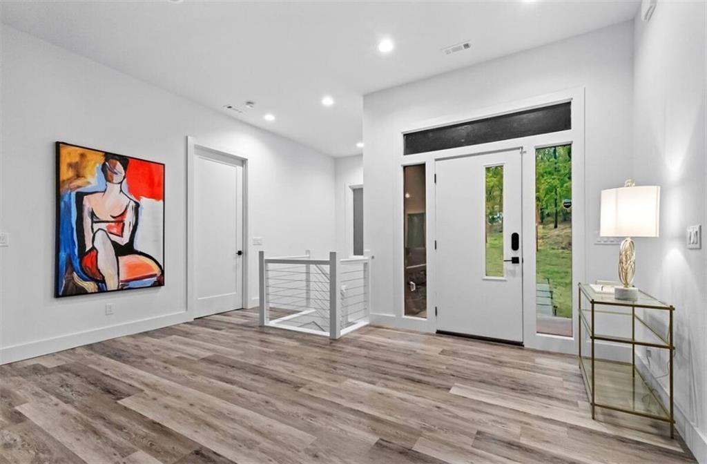 Image 2: Contemporary entry with LVP flooring, recessed lig