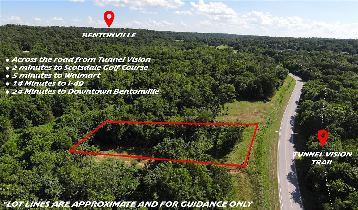 Image 1: Cleared land parcel bordered by dense tree coverag