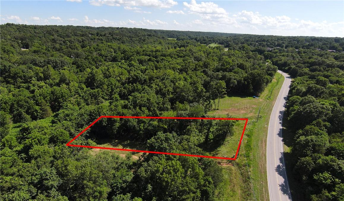 Image 2: Wooded lot featuring a partially cleared area and