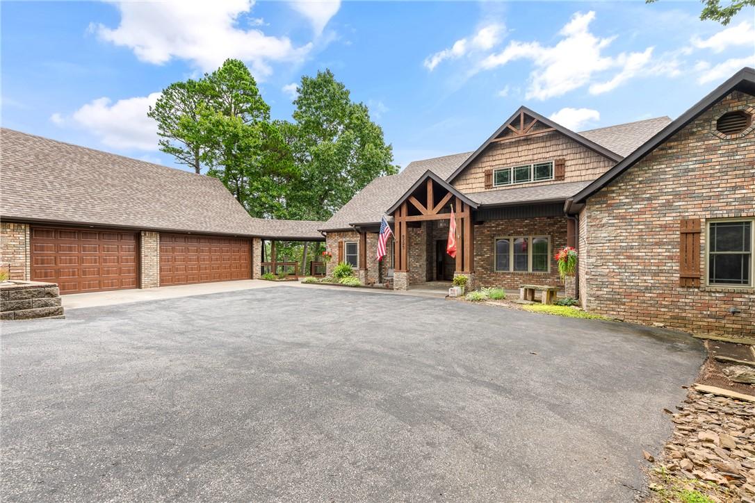 Image 3: Multi-level brick and shingle exterior featuring a