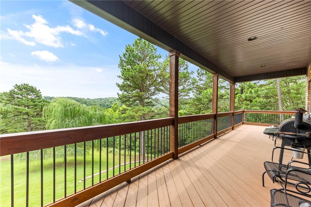 Image 4: Expansive covered deck featuring wood-finish floor
