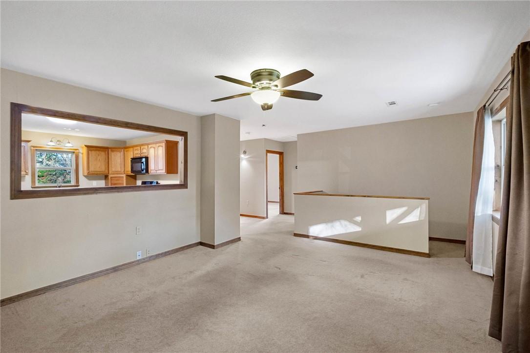 Image 3: Main level living room with light carpet and ceili