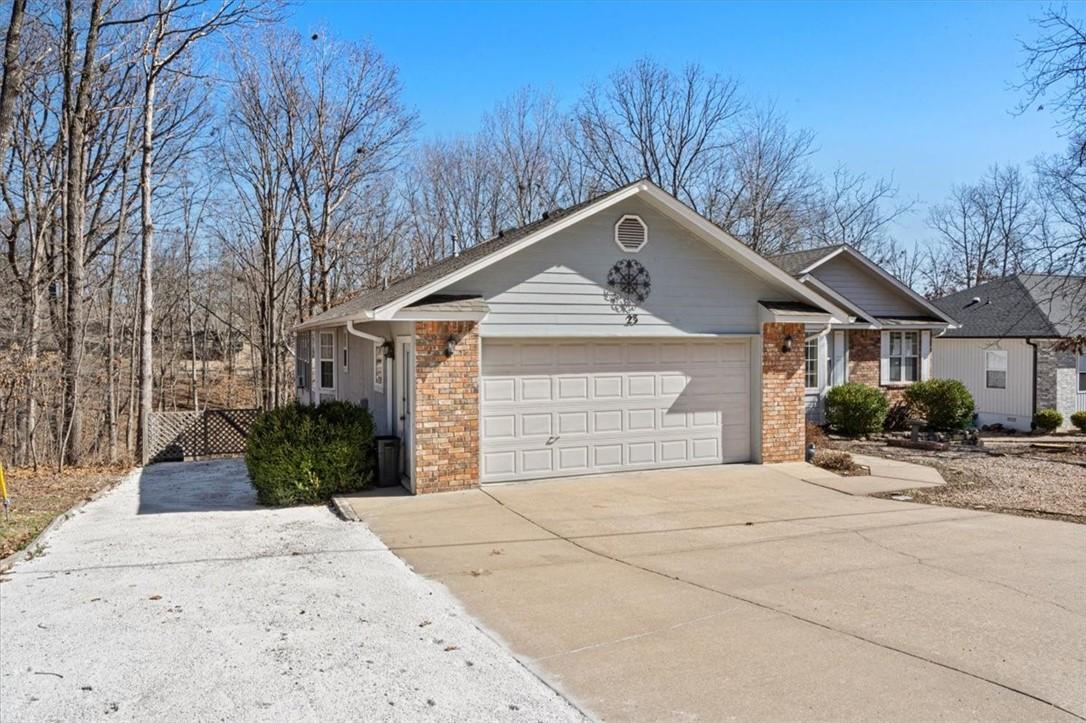 Image 3: Single story home featuring a garage, concrete dri