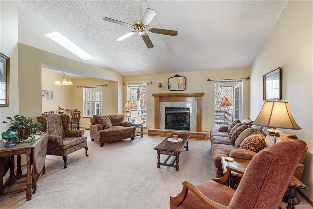 Image 4: Living area featuring a glass covered fireplace, l