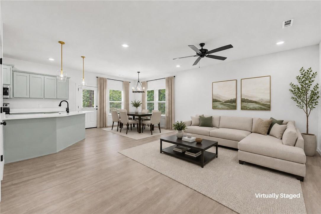 Image 3: Virtually staged main living area and kitchen.