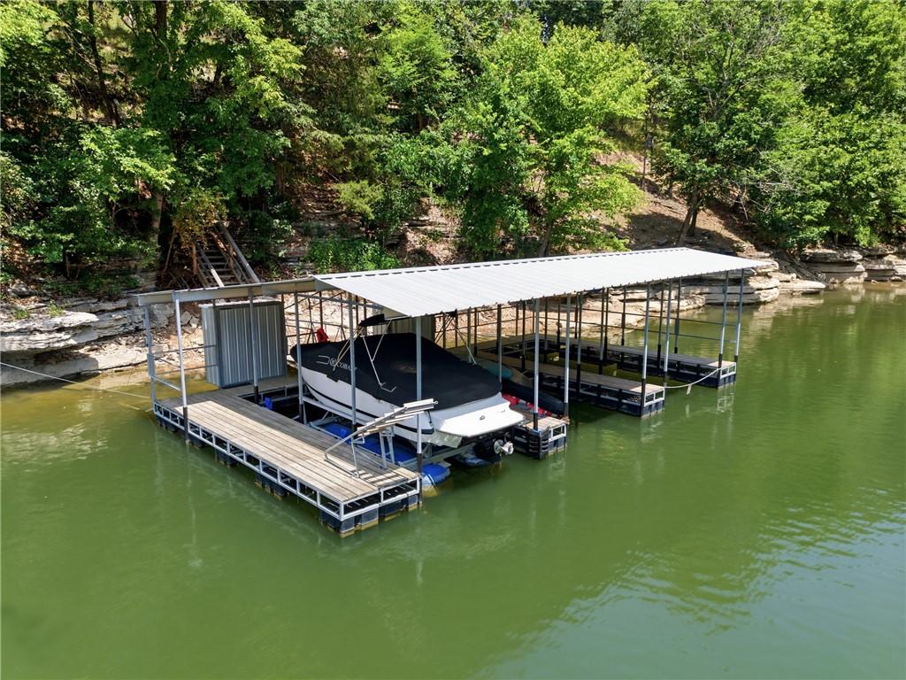 Image 3: Covered boat dock featuring a metal roof, multiple