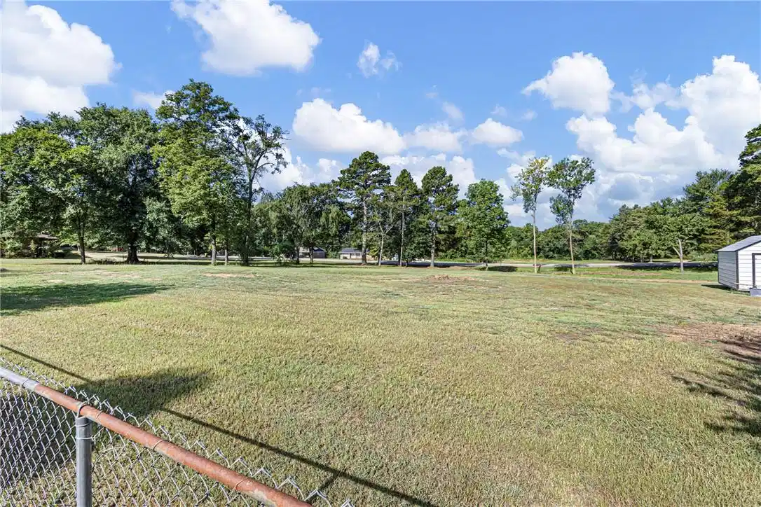 Image 1: Expansive outdoor area featuring a lush green lawn