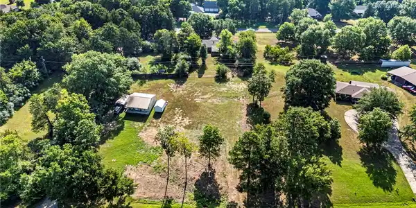 Image 4: Expansive cleared lot with mature trees throughout