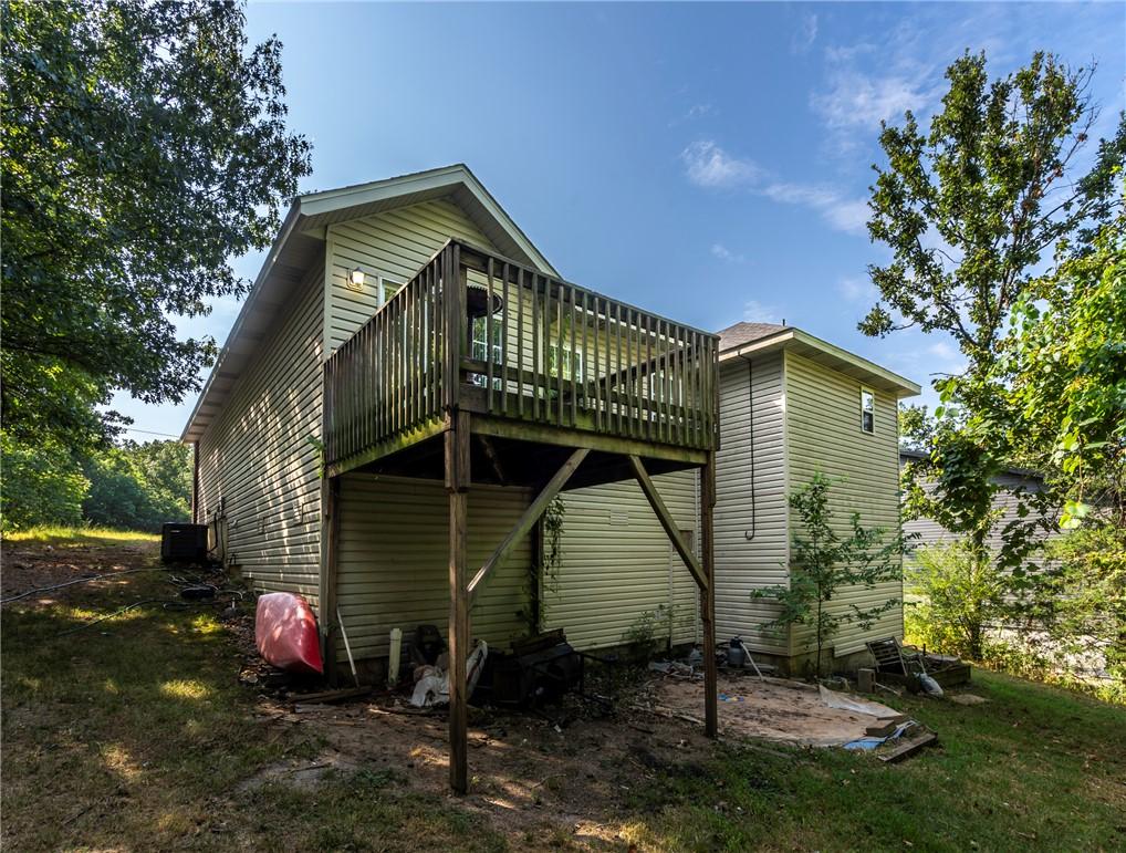 Image 4: Beige siding exterior with a multi-level wood deck