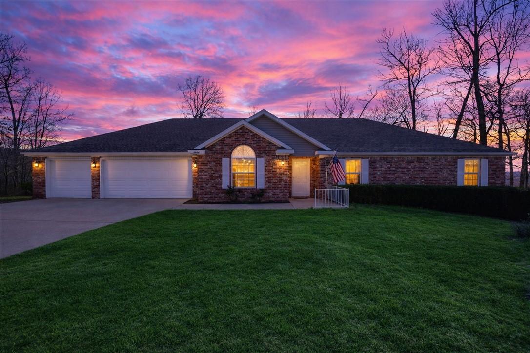 Image 2: Single story home with a 3 car attached garage, an