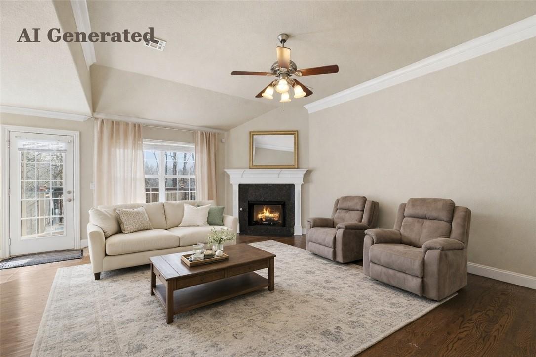 Image 3: Living area featuring a vaulted ceiling with a fan