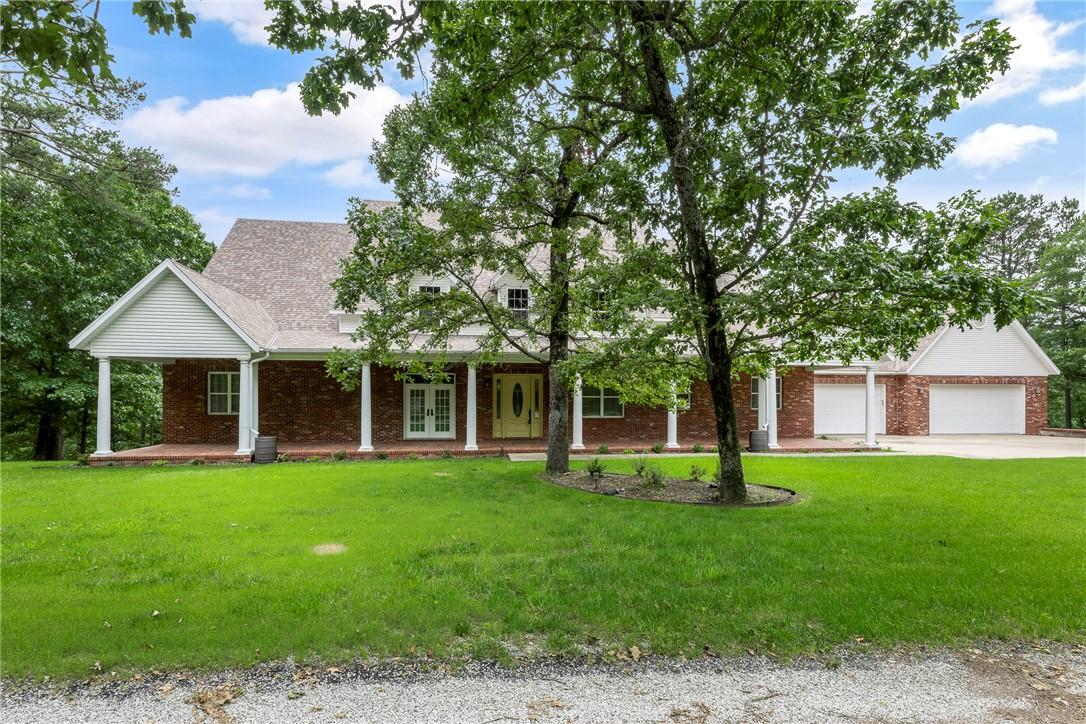 Image 3: View of front facade with a front yard, french doo