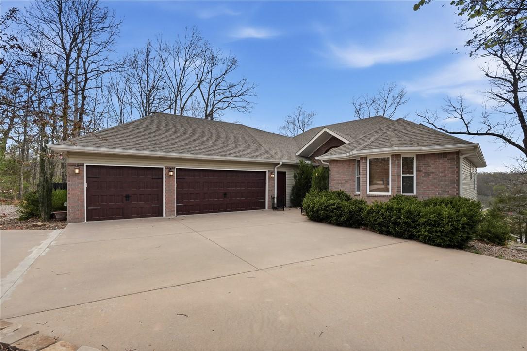 Image 2: Home with brick siding, an attached garage and cir