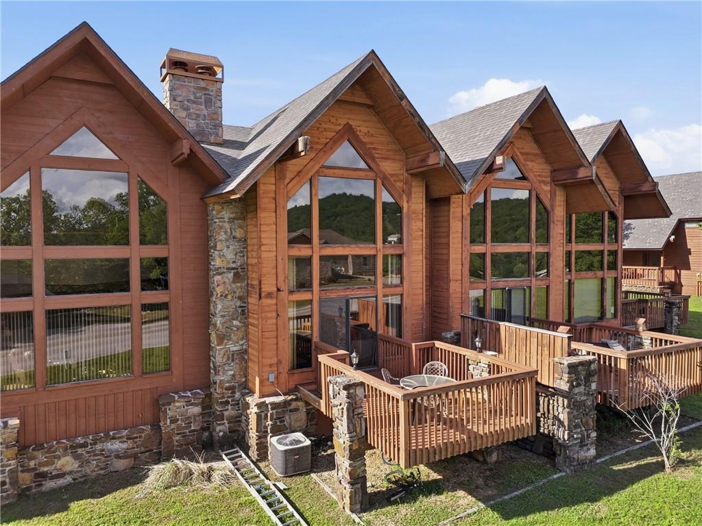 Image 2: Multi-story exterior with wood siding, stone accen