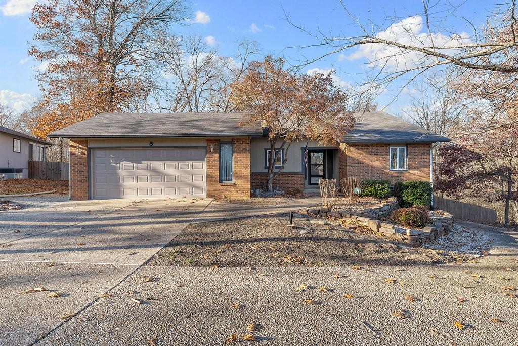 Image 1: Single story home featuring concrete driveway, bri