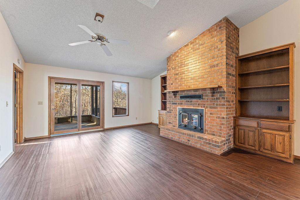 Image 3: Unfurnished living room with a textured ceiling, v