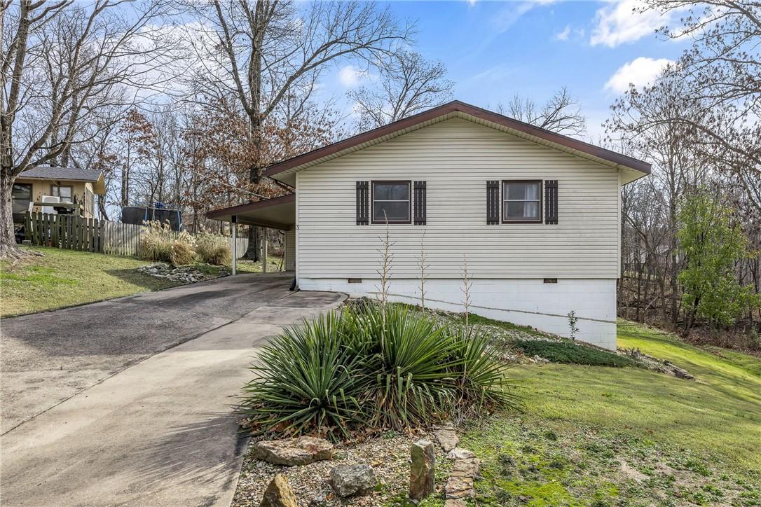 Image 1: View of front of house with driveway, an attached