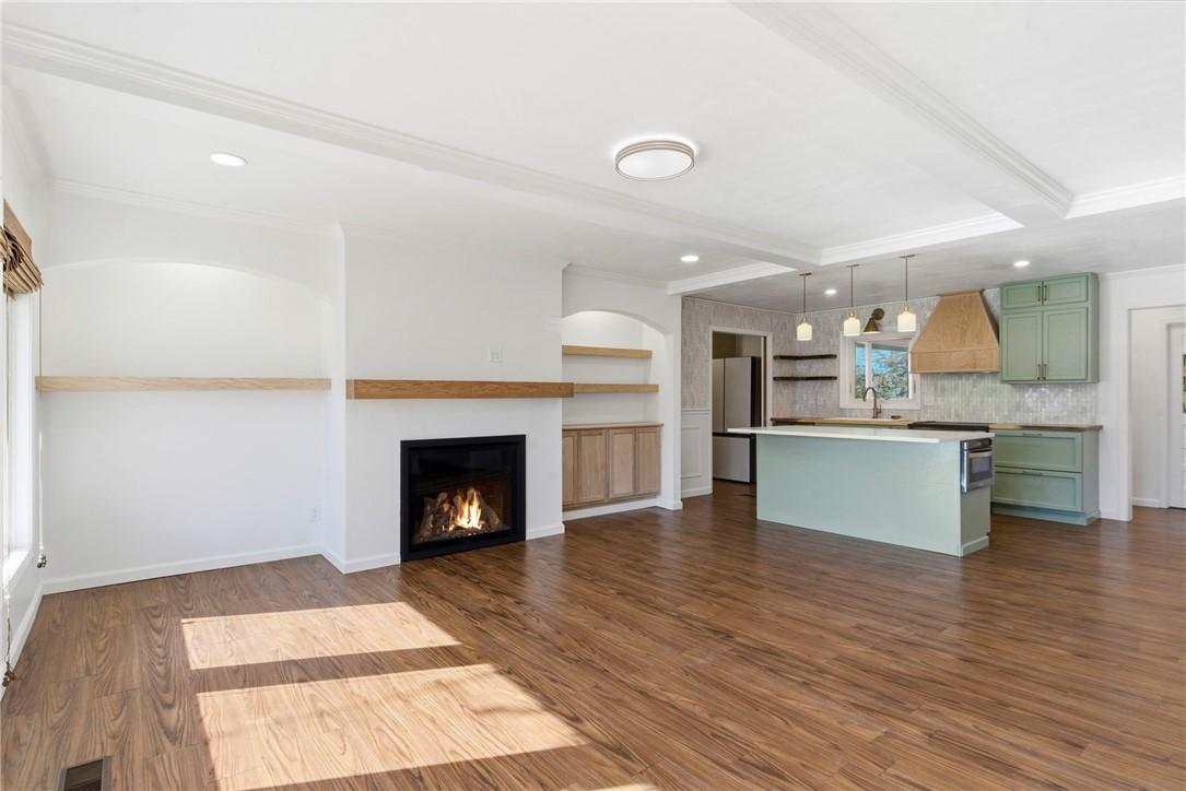 Image 2: Kitchen with green cabinetry, a kitchen island, ha
