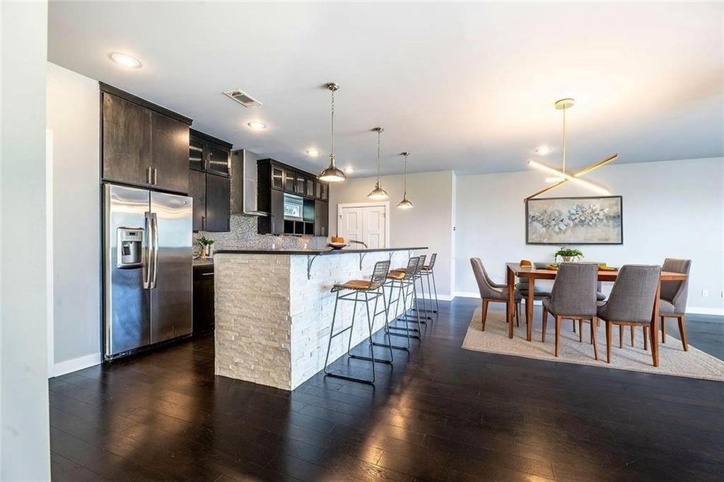 Image 1: Kitchen with stainless steel fridge with ice dispe