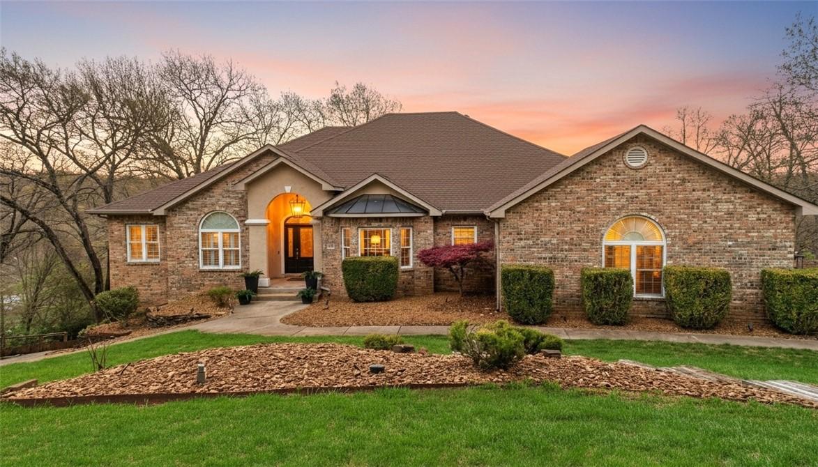Image 1: Ranch-style house featuring a front lawn and brick