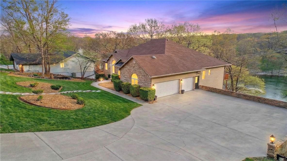 Image 3: Ranch-style home featuring concrete driveway, a ya
