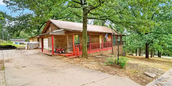 Image 3: Wood-sided home featuring a covered front porch wi