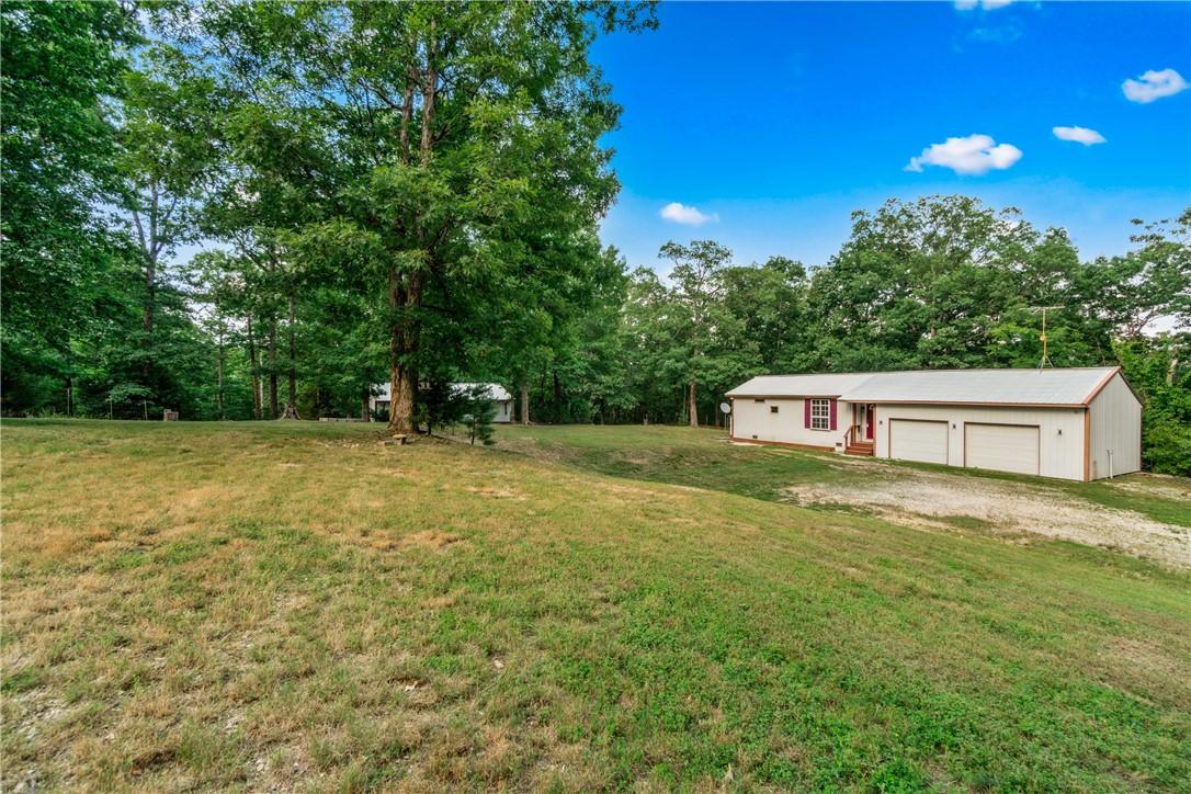 Image 1: Welcome home! Tucked beneath the trees, this cozy