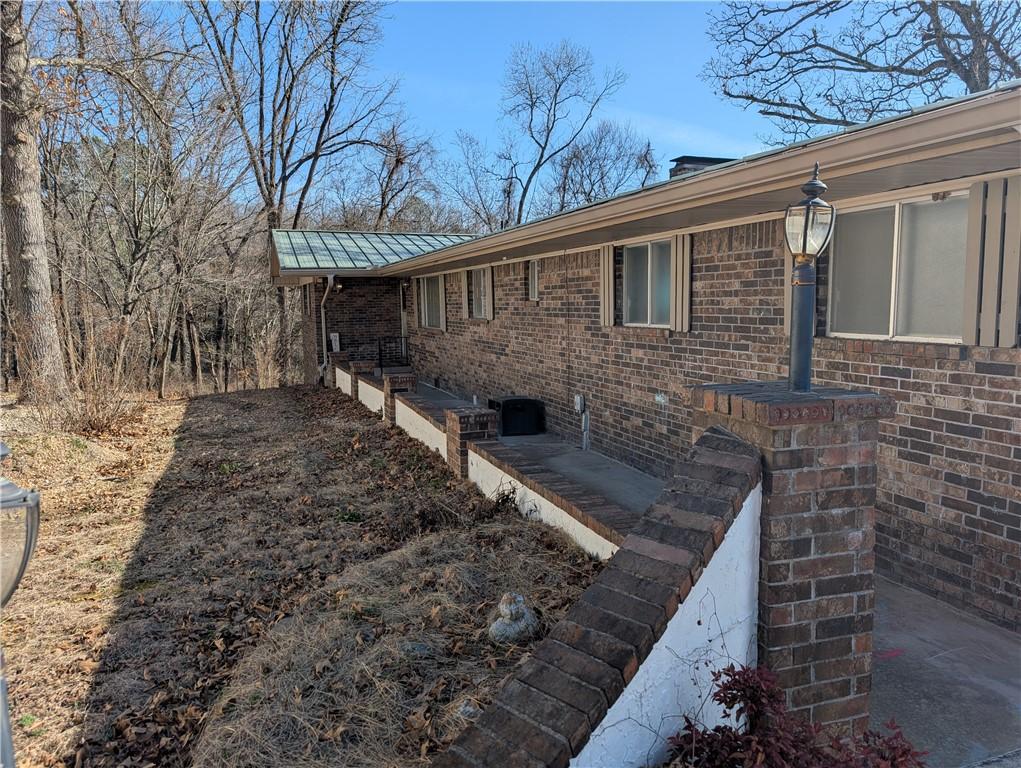Image 2: View of property exterior featuring brick siding a