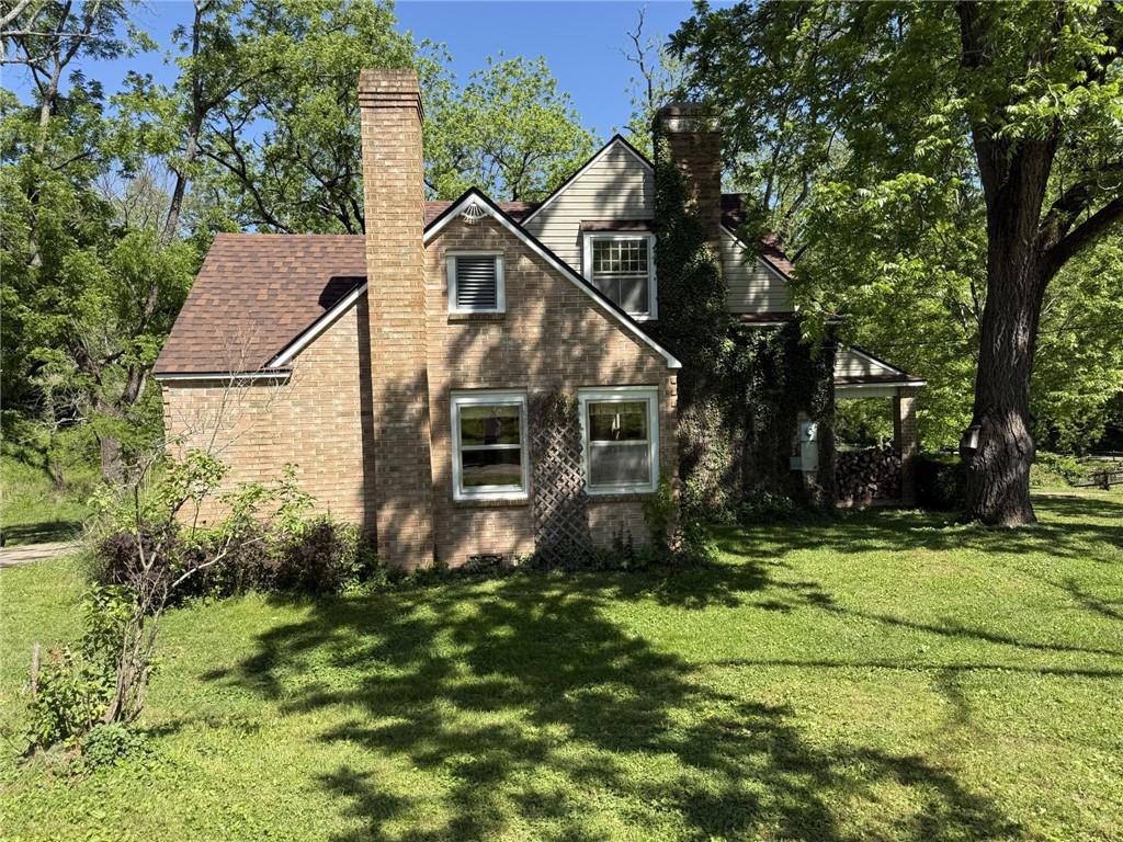 Image 2: Brick and siding exterior with gabled roof lines