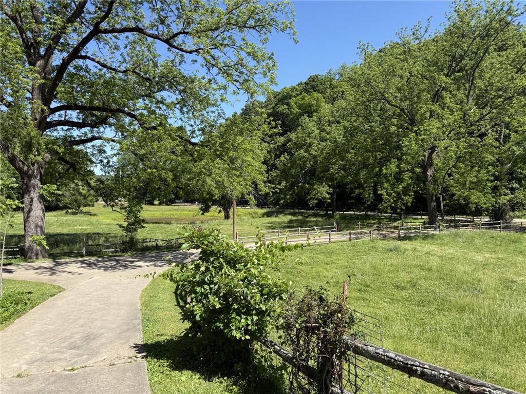 Image 3: Expansive green space featuring a concrete pathway
