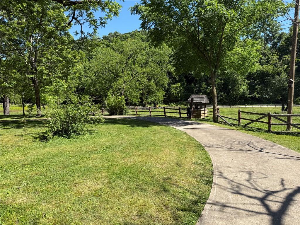 Image 4: Concrete driveway leading to a decorative wooden w