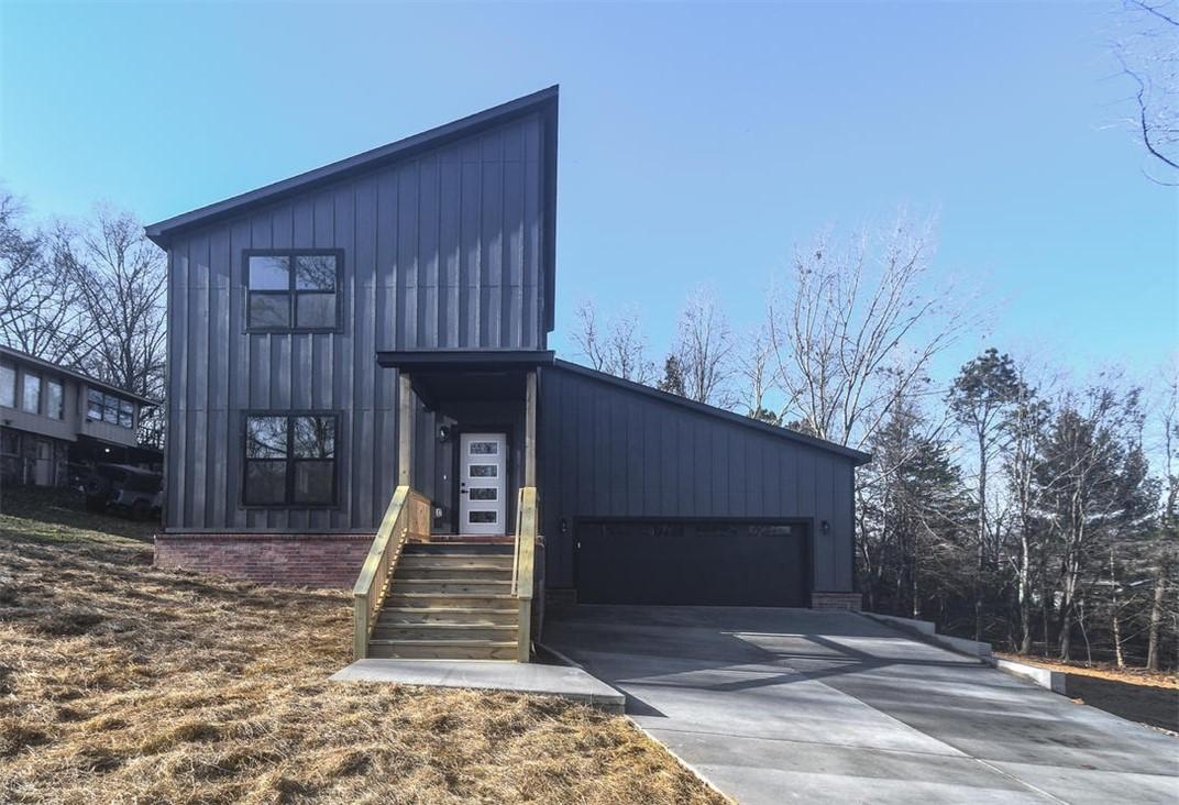 Image 2: View of property with driveway