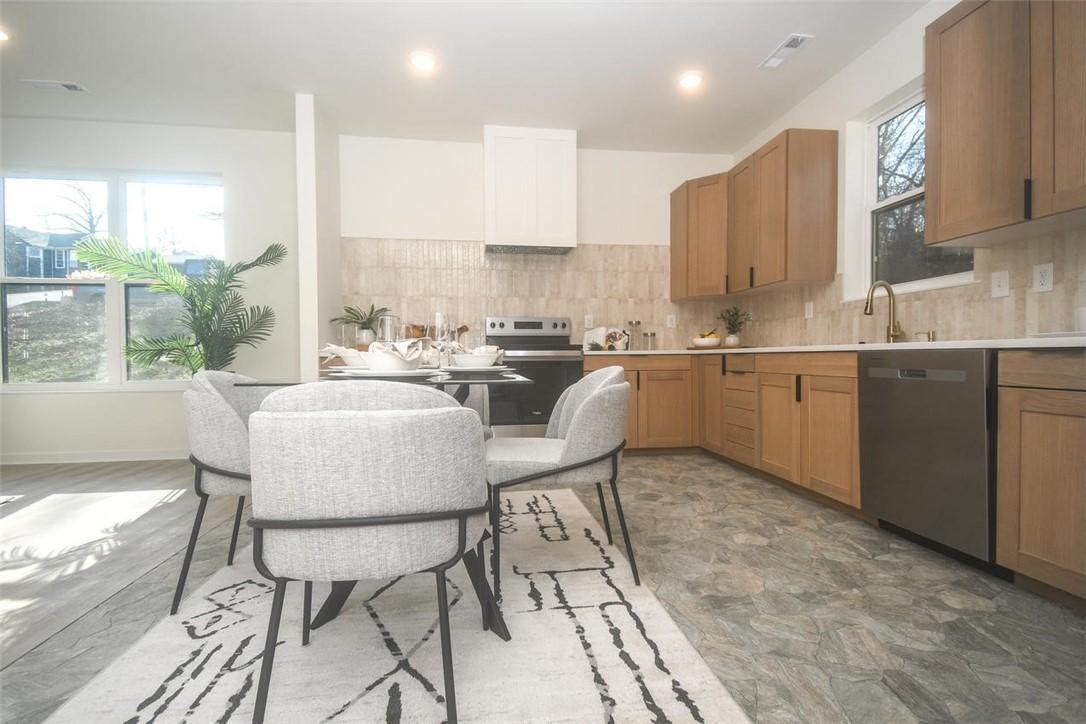 Image 3: Kitchen with light countertops, stainless steel ap
