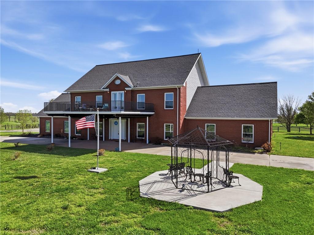 Image 2: Front of property featuring a lawn, brick siding,