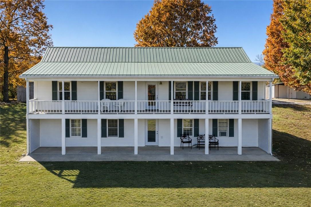 Image 4: Rear view of property featuring a metal roof and a