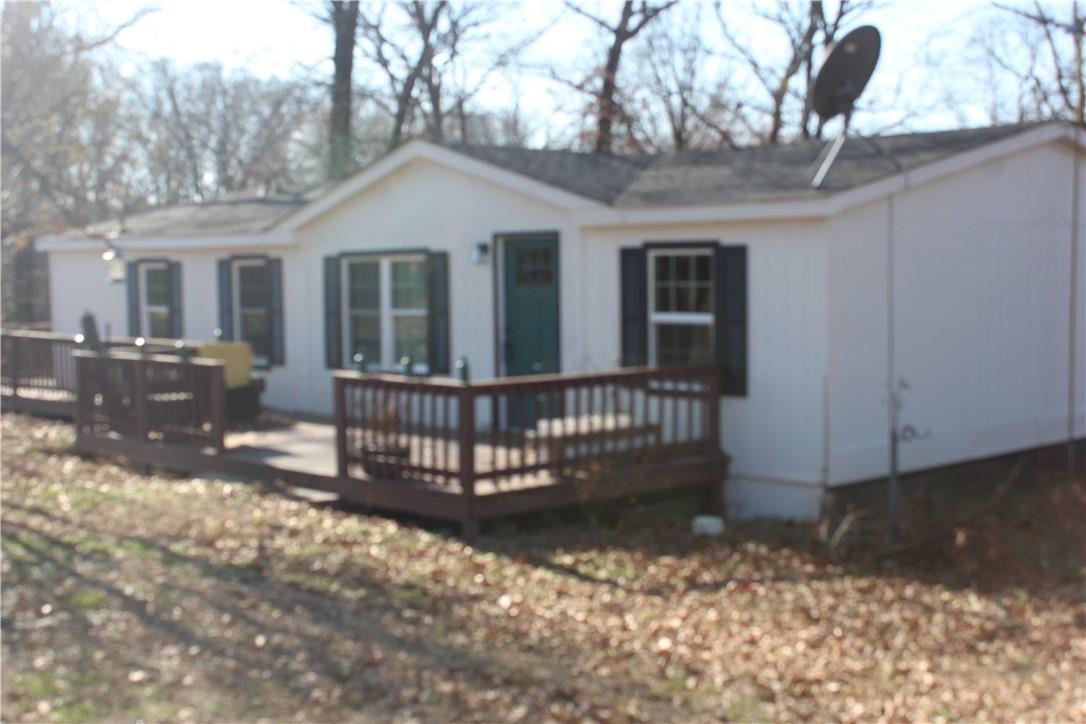 Image 1: Back of house with a wooden deck