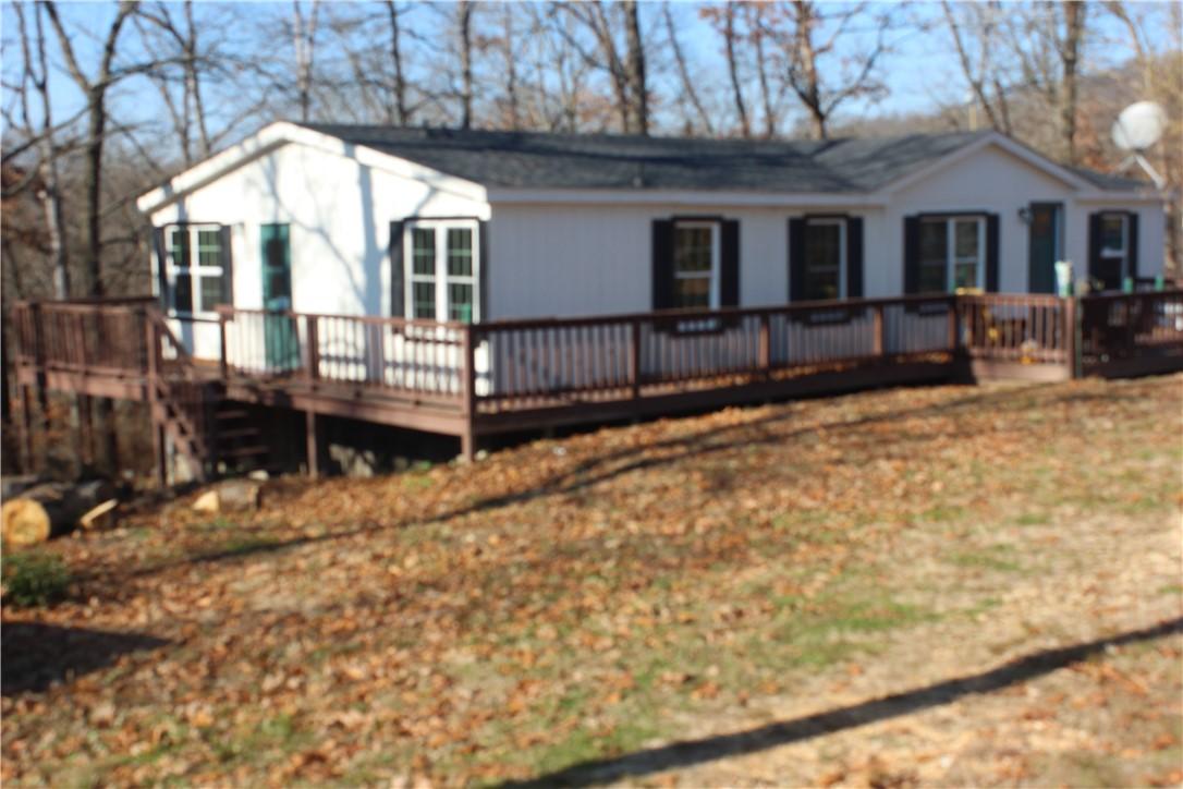 Image 2: View of front of property with a deck