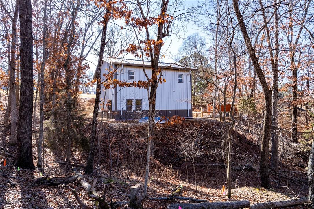 Image 3: View of back of home from lot. Storage building.