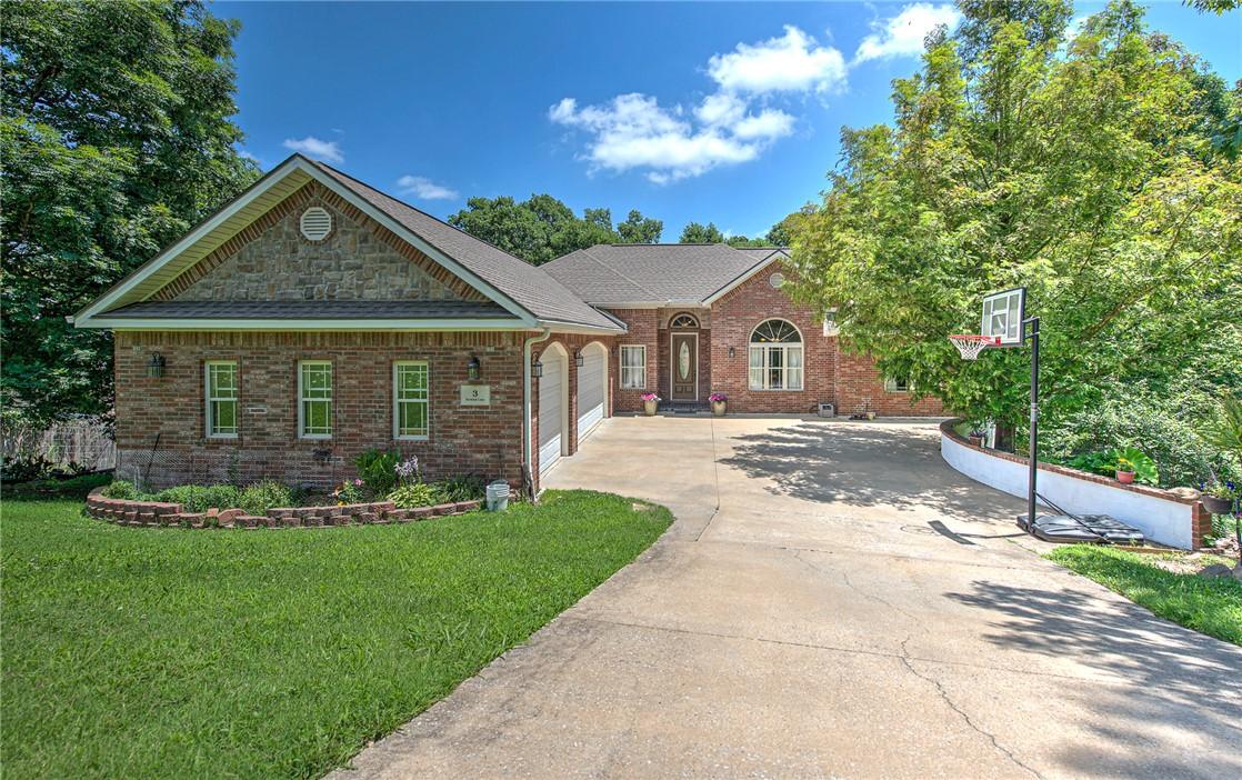 Image 2: Brick exterior with a stone-accented front gable