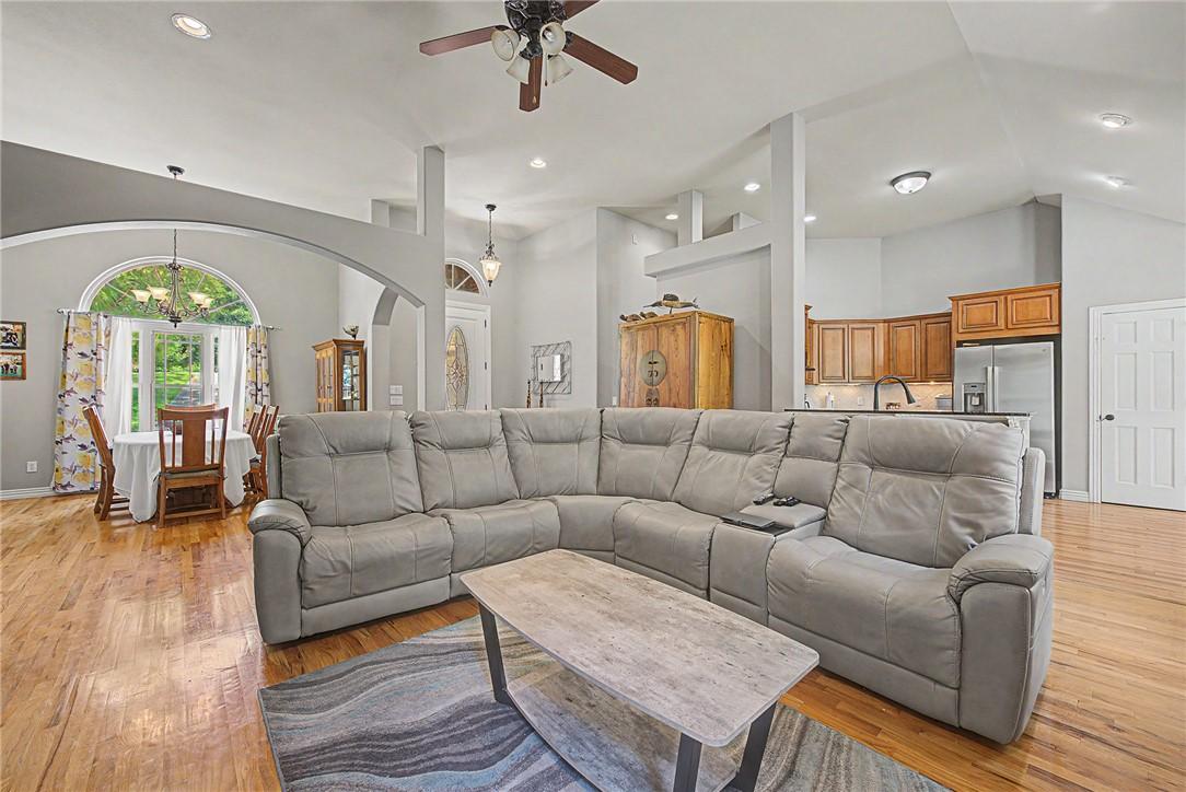 Image 4: Open-concept living area with wood-finish flooring