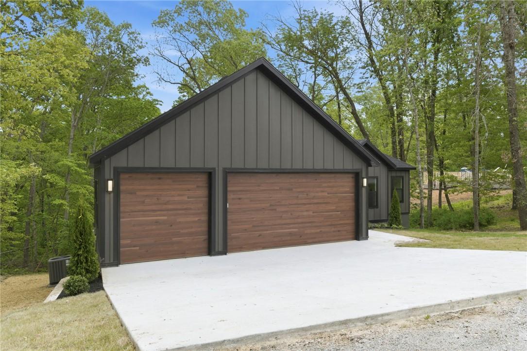 Image 4: Modern gabled exterior featuring vertical panel si