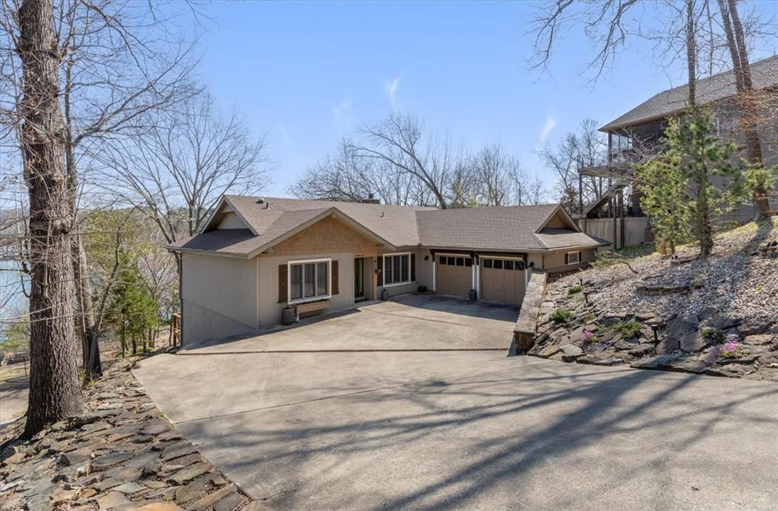 Image 1: View of front of house featuring an attached garag