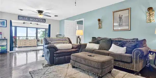 Image 4: Spacious living area featuring expansive glass doo