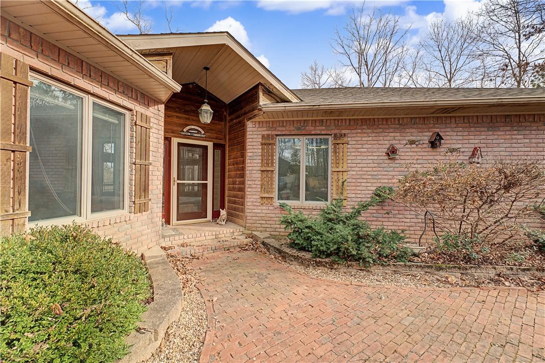 Image 3: Property entrance featuring brick siding and a shi