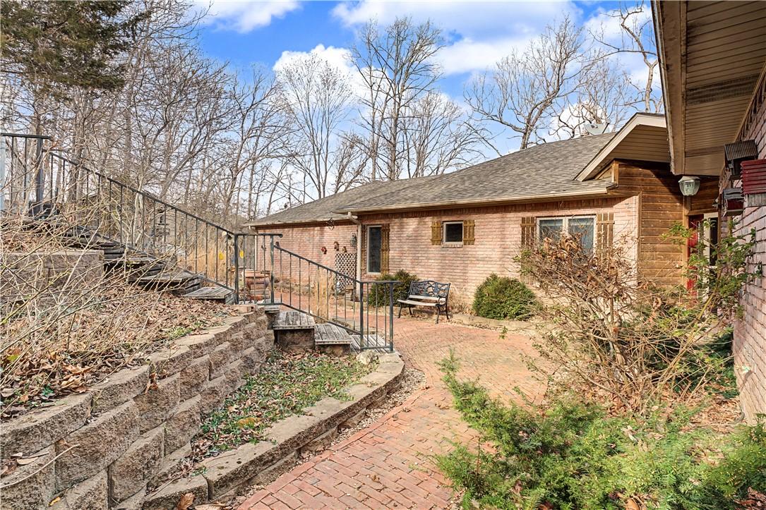 Image 4: View of side of property with concrete driveway
