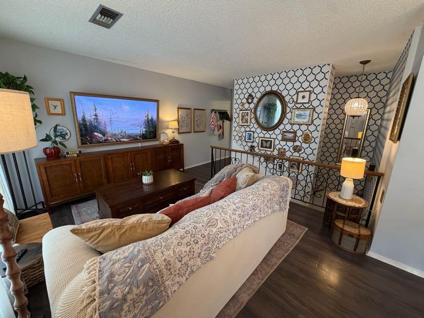 Image 2: Living room featuring dark wood-style floors, a te