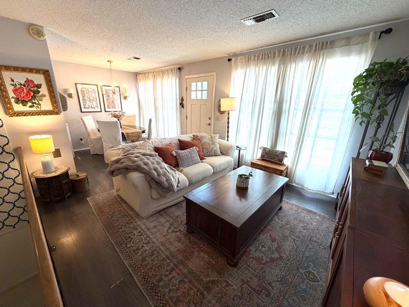 Image 4: Living room featuring dark wood-type flooring and