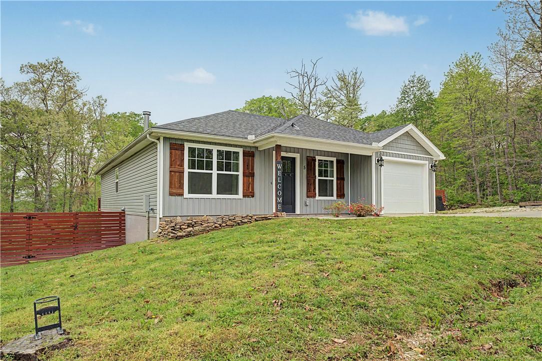 Image 2: The property features a gray exterior with white t